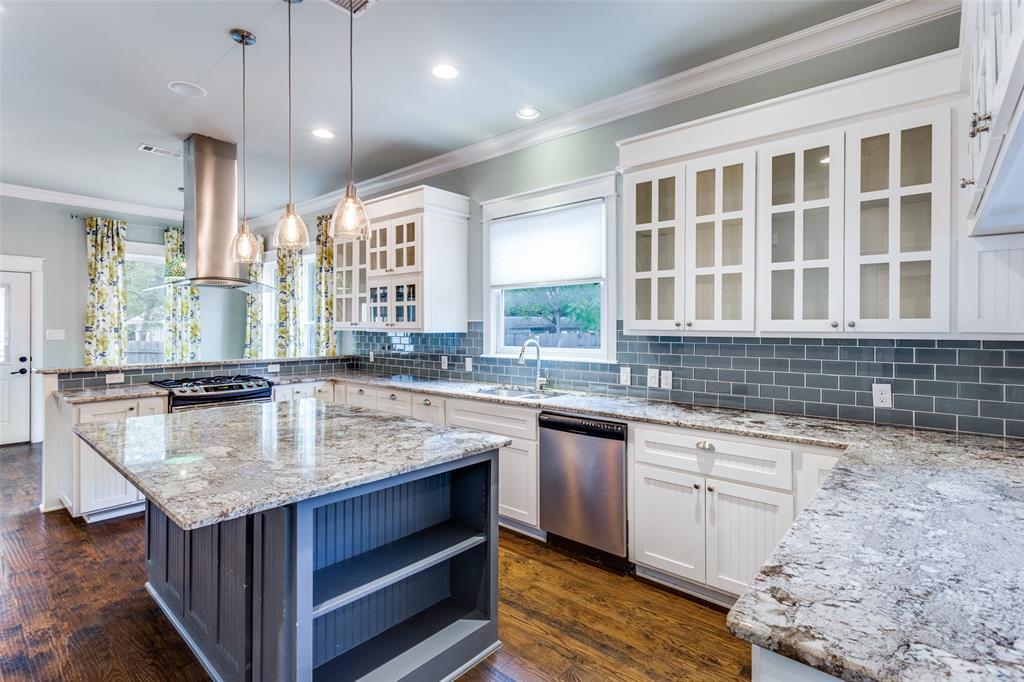 a kitchen with a stove sink and cabinets