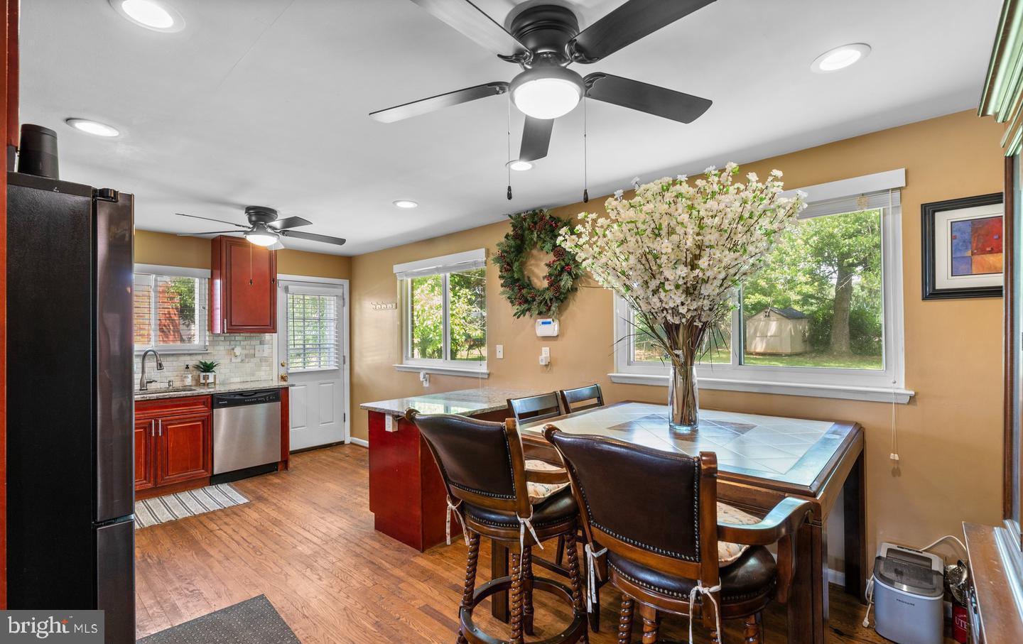 a view of a dining room with furniture window and wooden floor