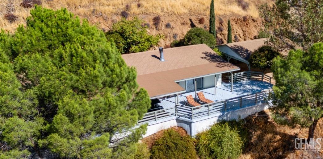 an aerial view of a house with a yard swimming pool and outdoor seating