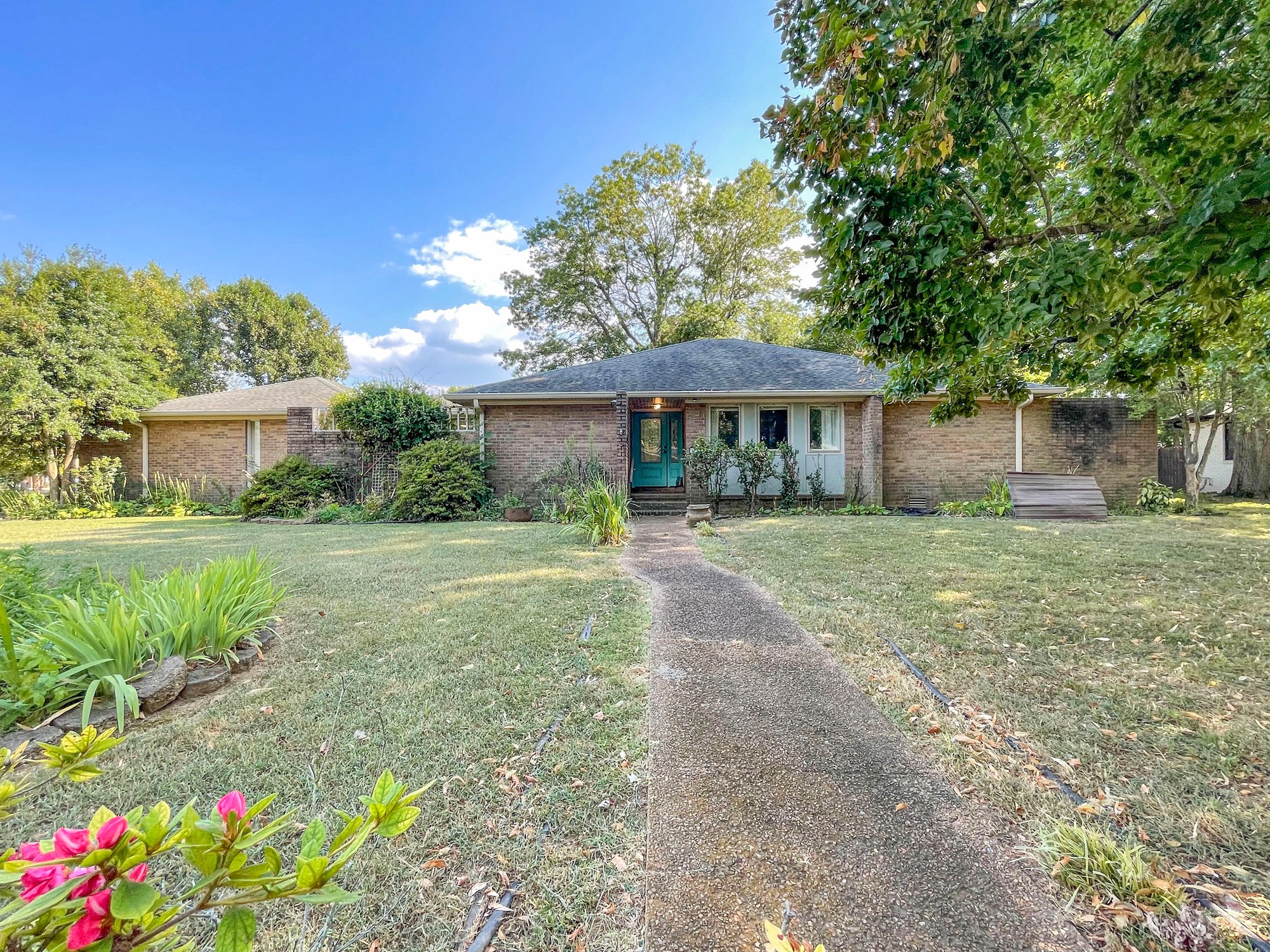 a front view of a house with garden