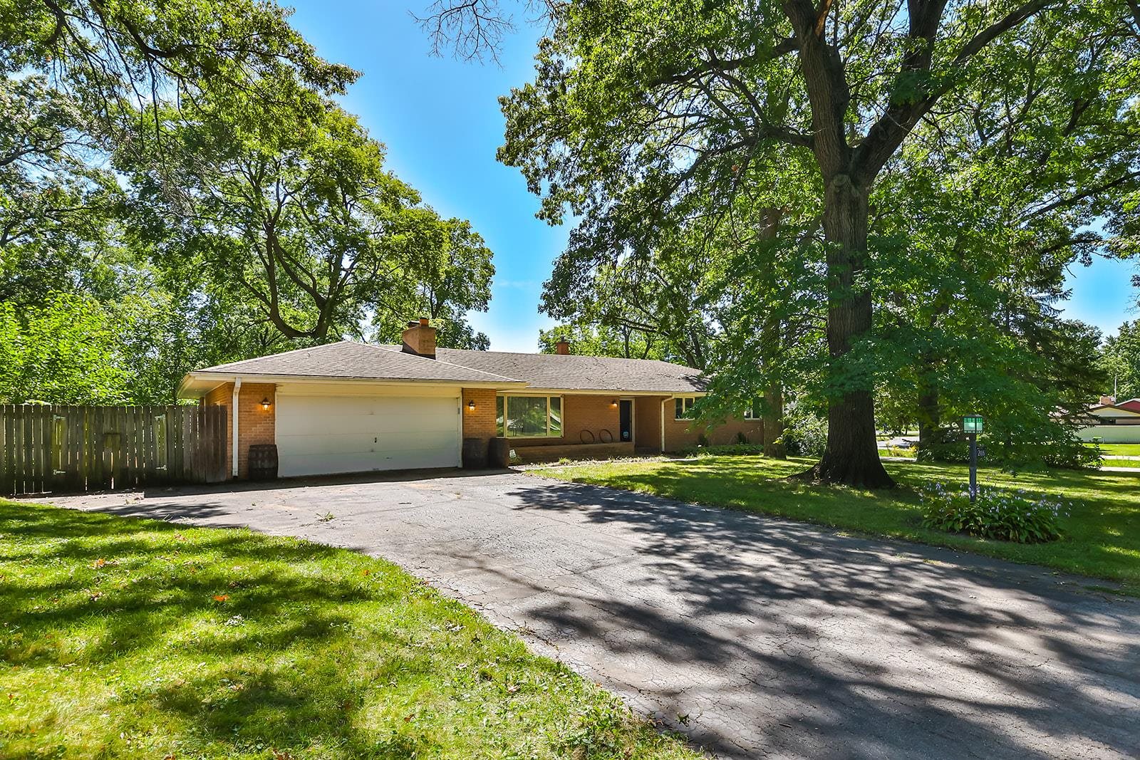 a front view of house with yard and trees