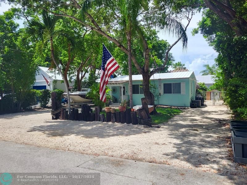 a view of a house with a yard and tree s