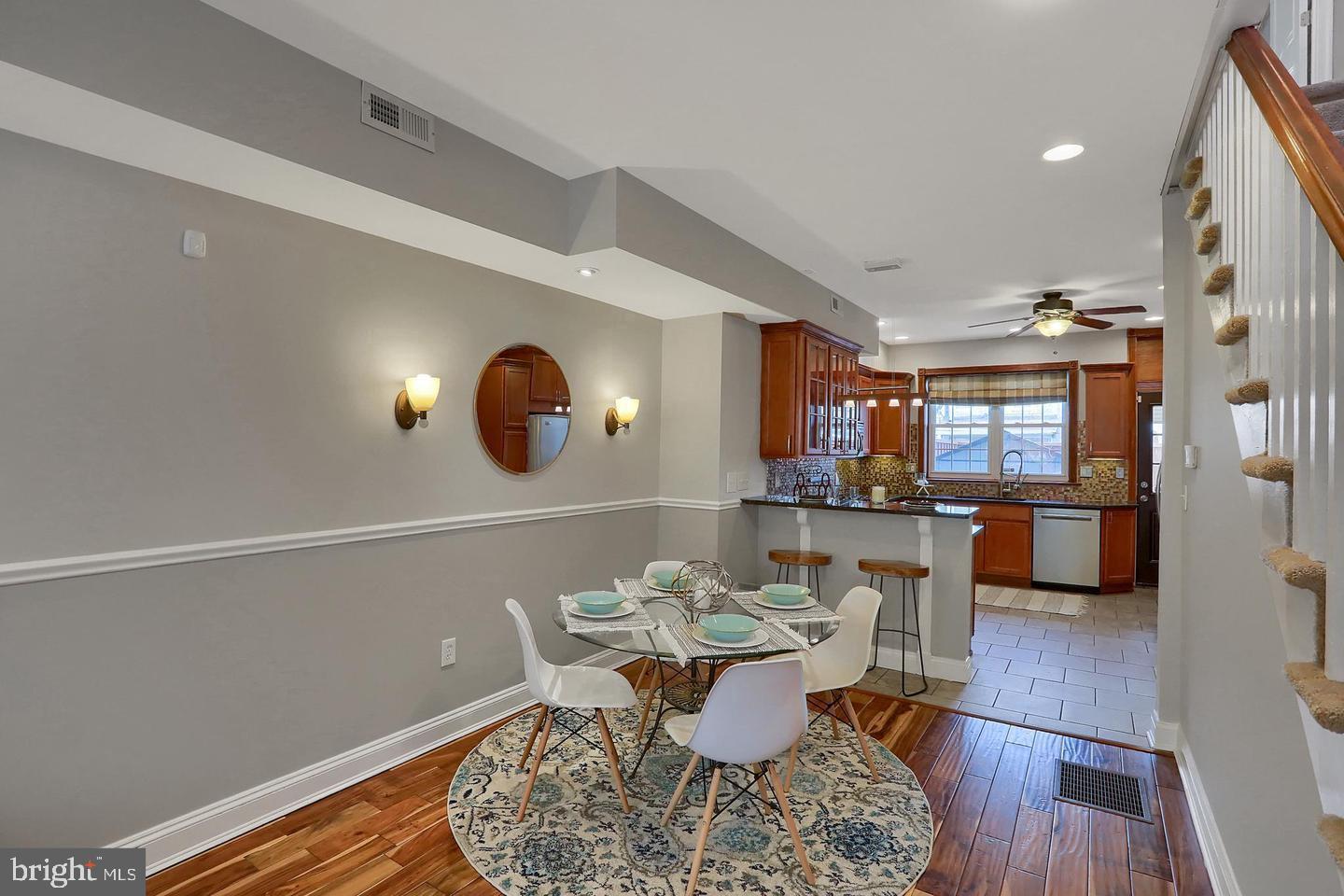 a view of a dining room with furniture and wooden floor