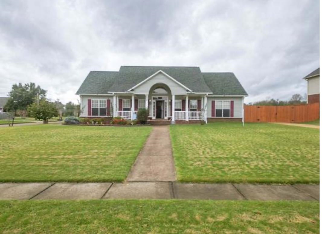 a front view of a house with garden