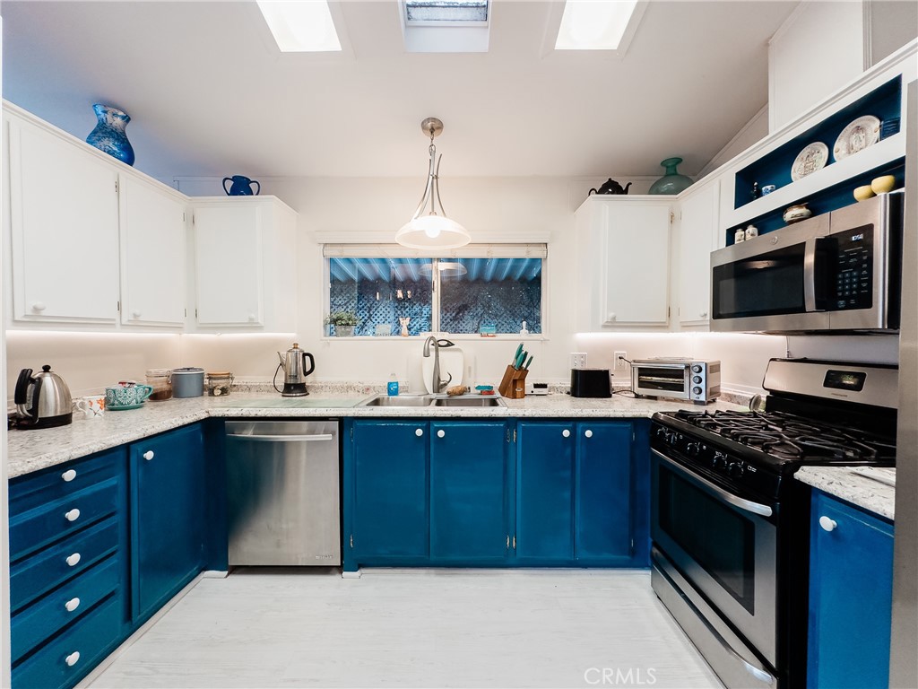 a kitchen with stainless steel appliances a stove sink and cabinets