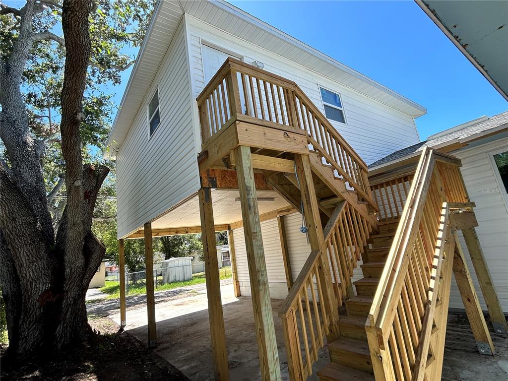 a view of balcony with wooden floor and fence