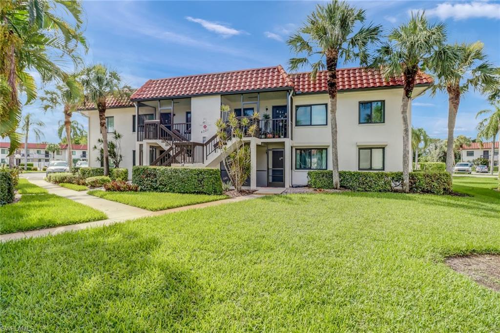 Condo entry featuring a lawn