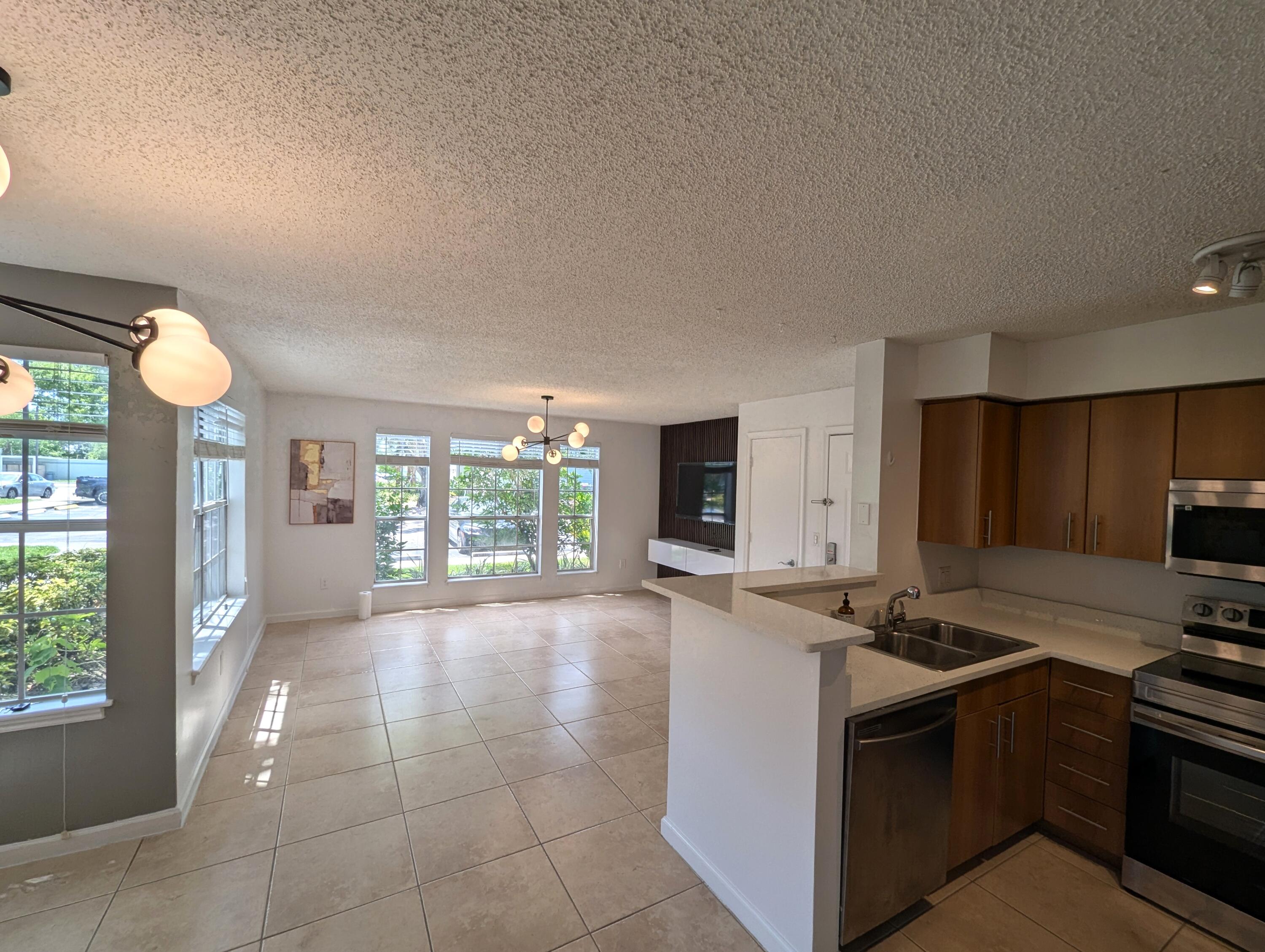 a kitchen with stainless steel appliances a stove a sink and a microwave