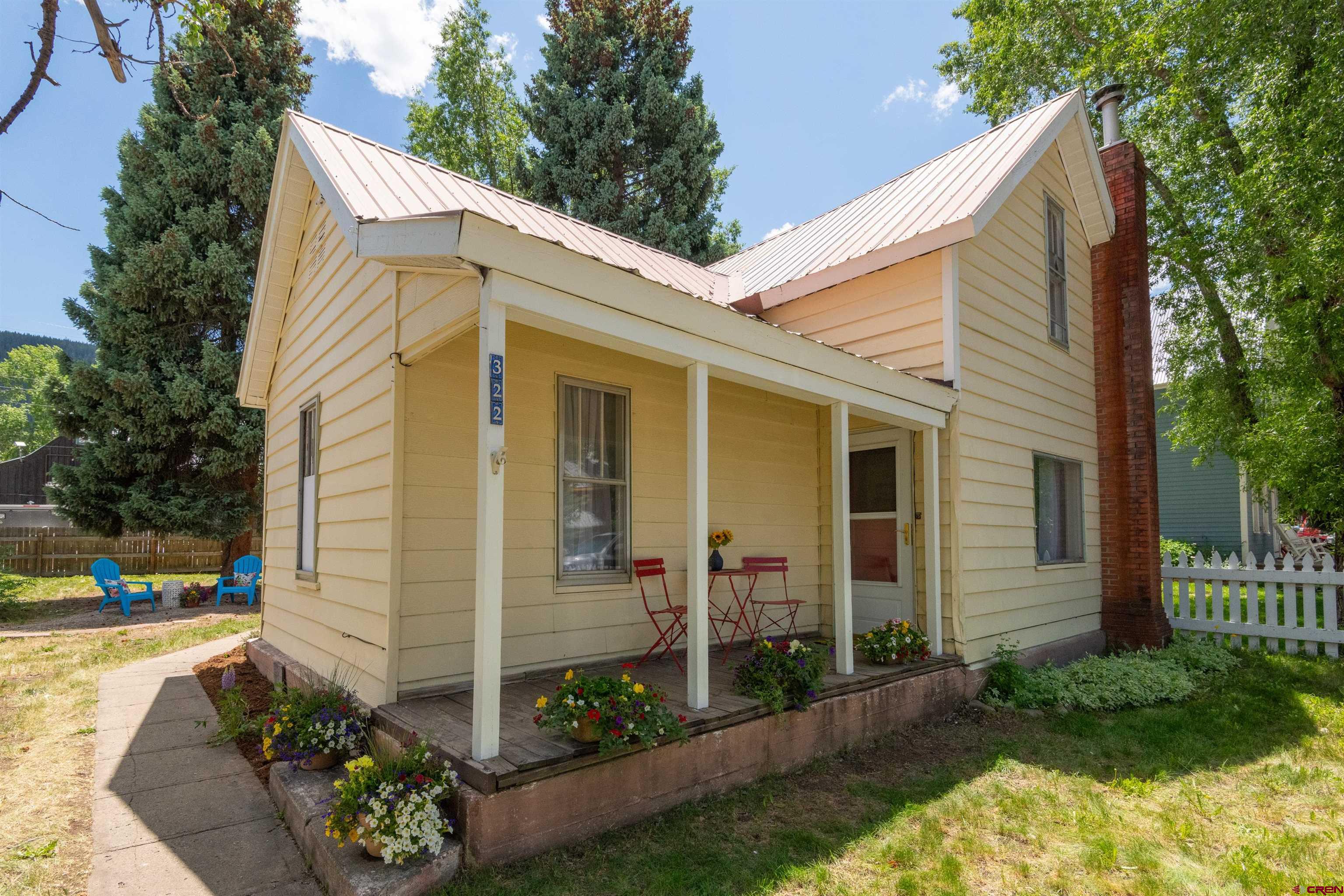 a view of a house with yard and a garden