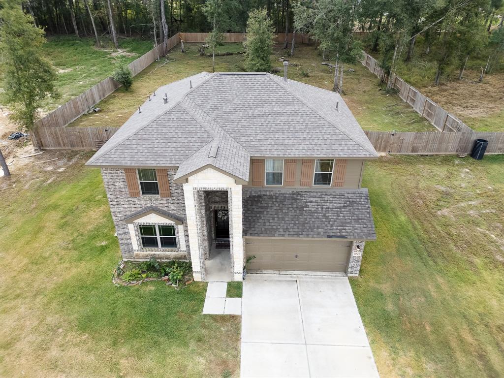 a aerial view of a house with a yard