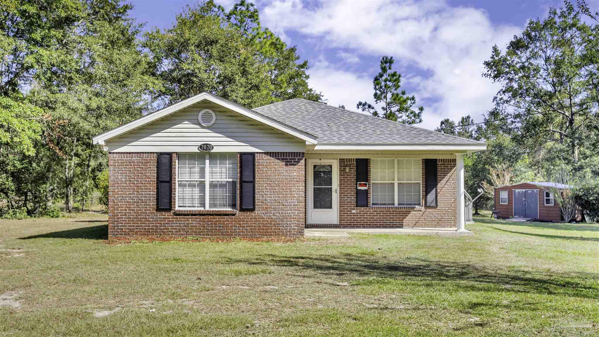 a front view of a house with a yard outdoor seating and yard