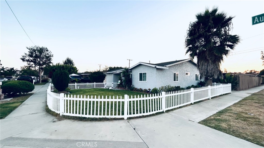 a view of a house with a deck and a yard