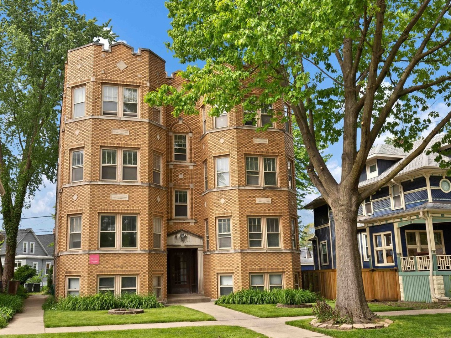 a front view of a building with a garden