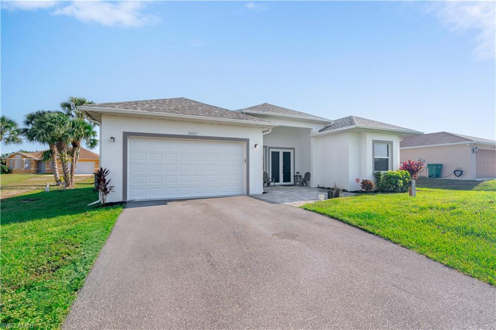 a front view of a house with a yard and garage