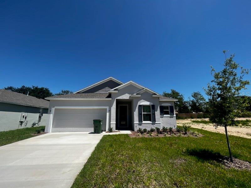 a front view of a house with a yard