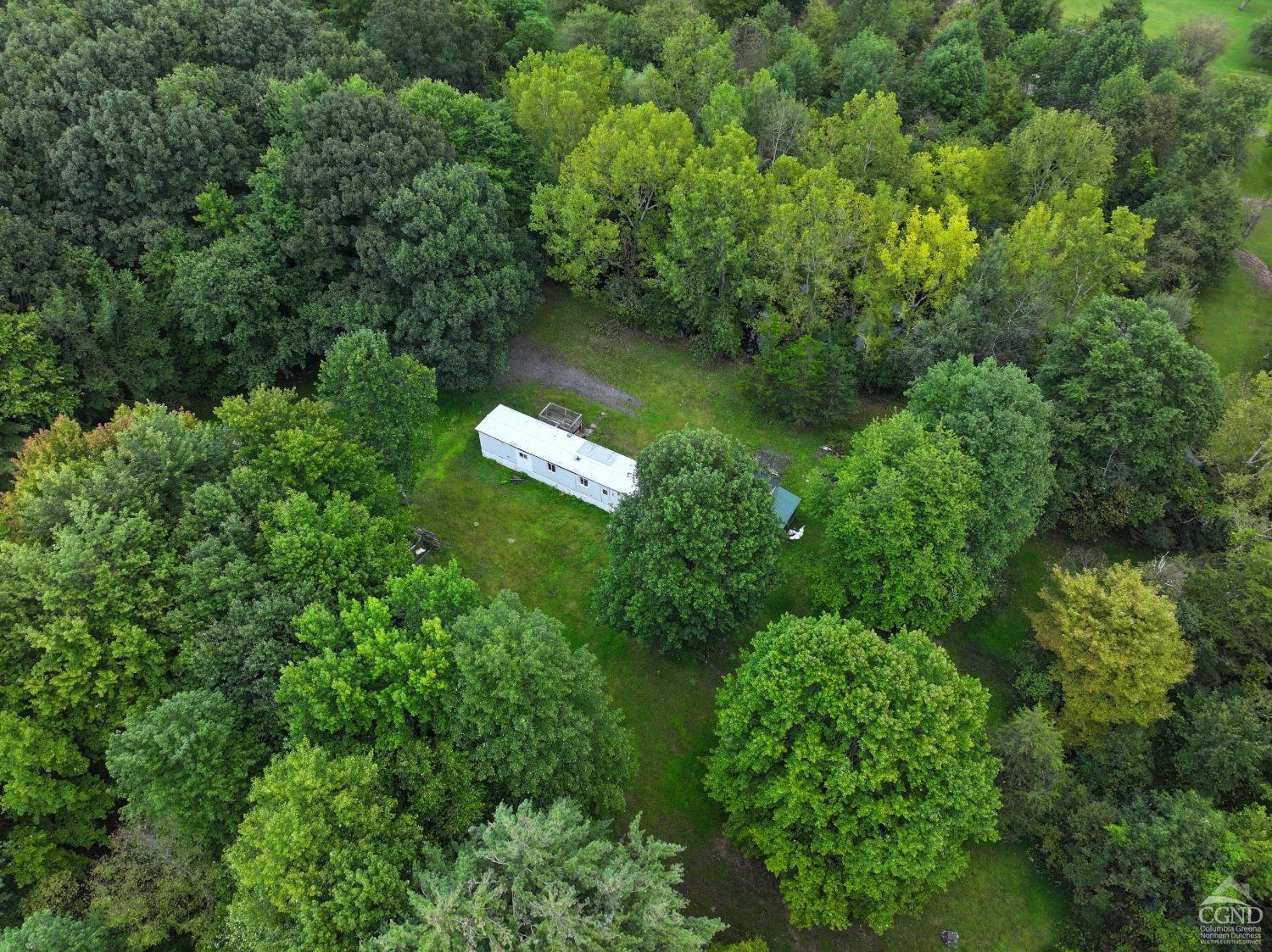 an aerial view of a house with a yard