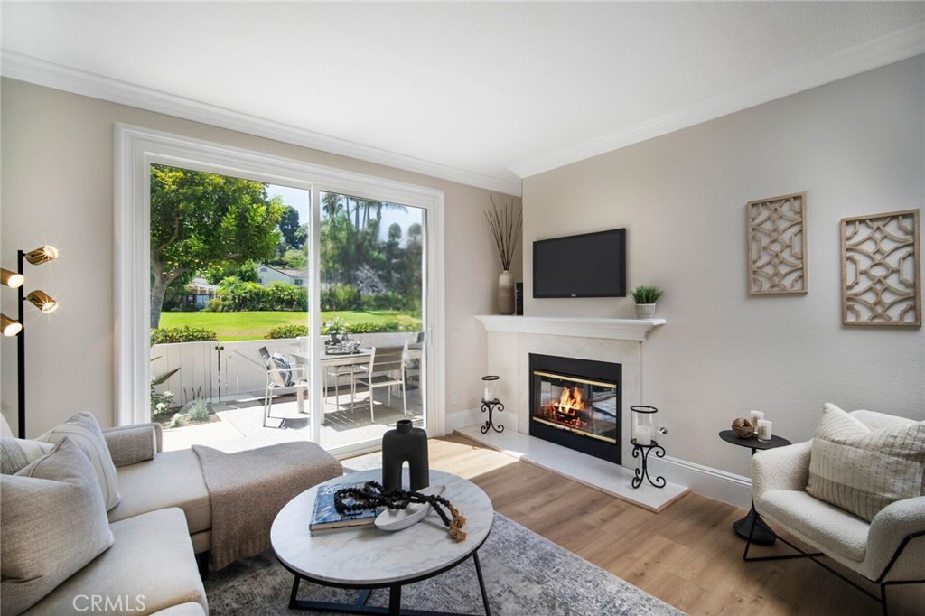 a living room with furniture fireplace and a large window