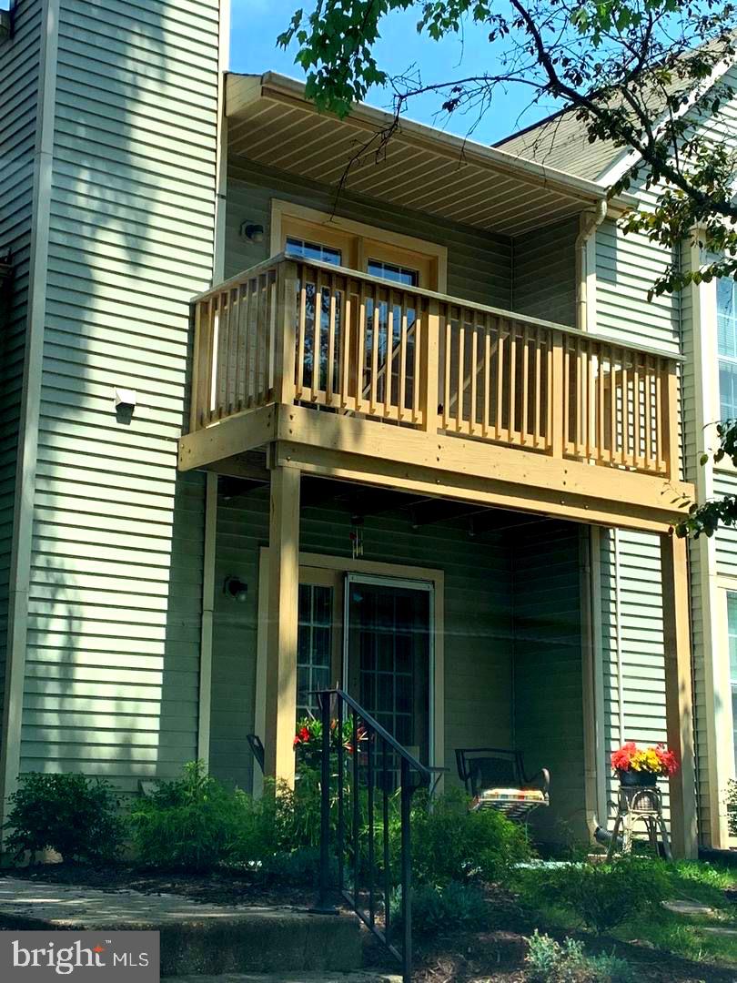 a front view of a house with plants and entryway