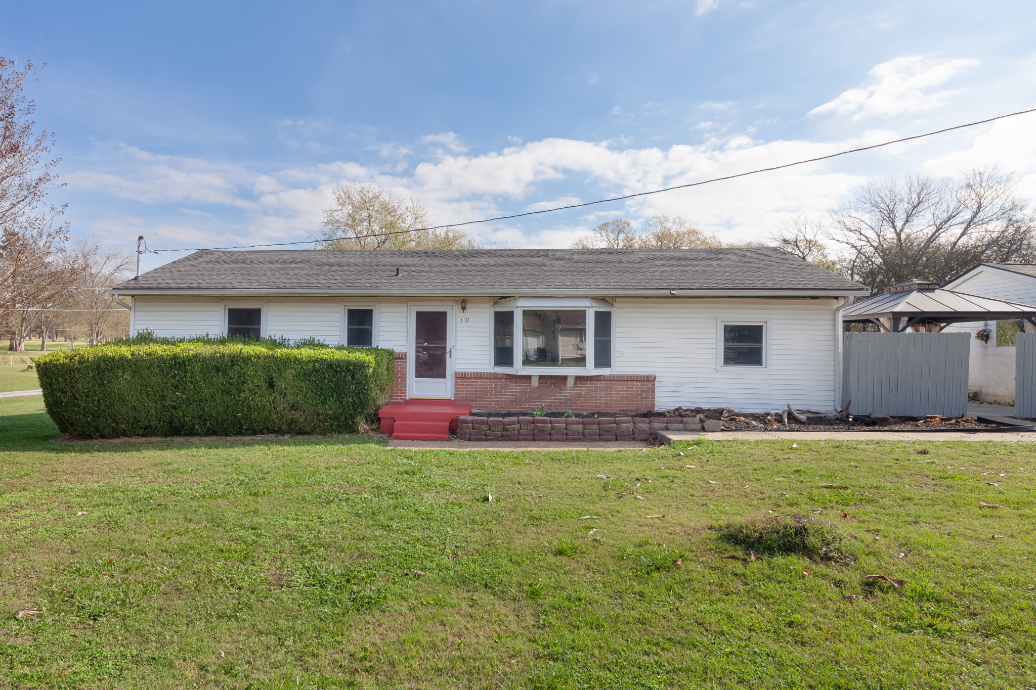 a view of a house with a yard and a porch