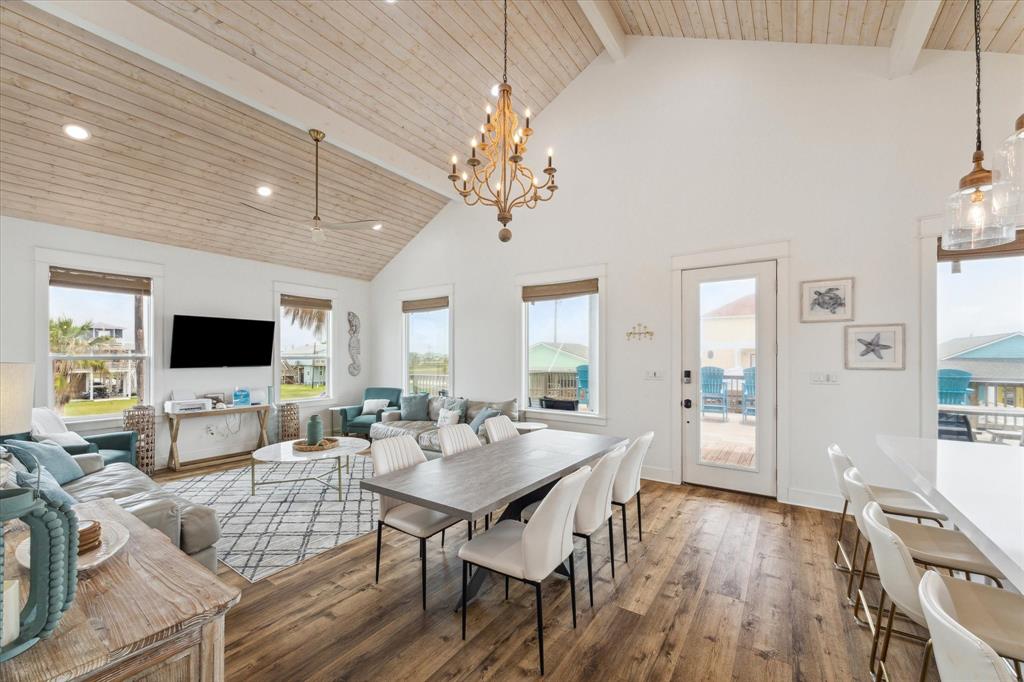 a living room with furniture dining table and a flat screen tv