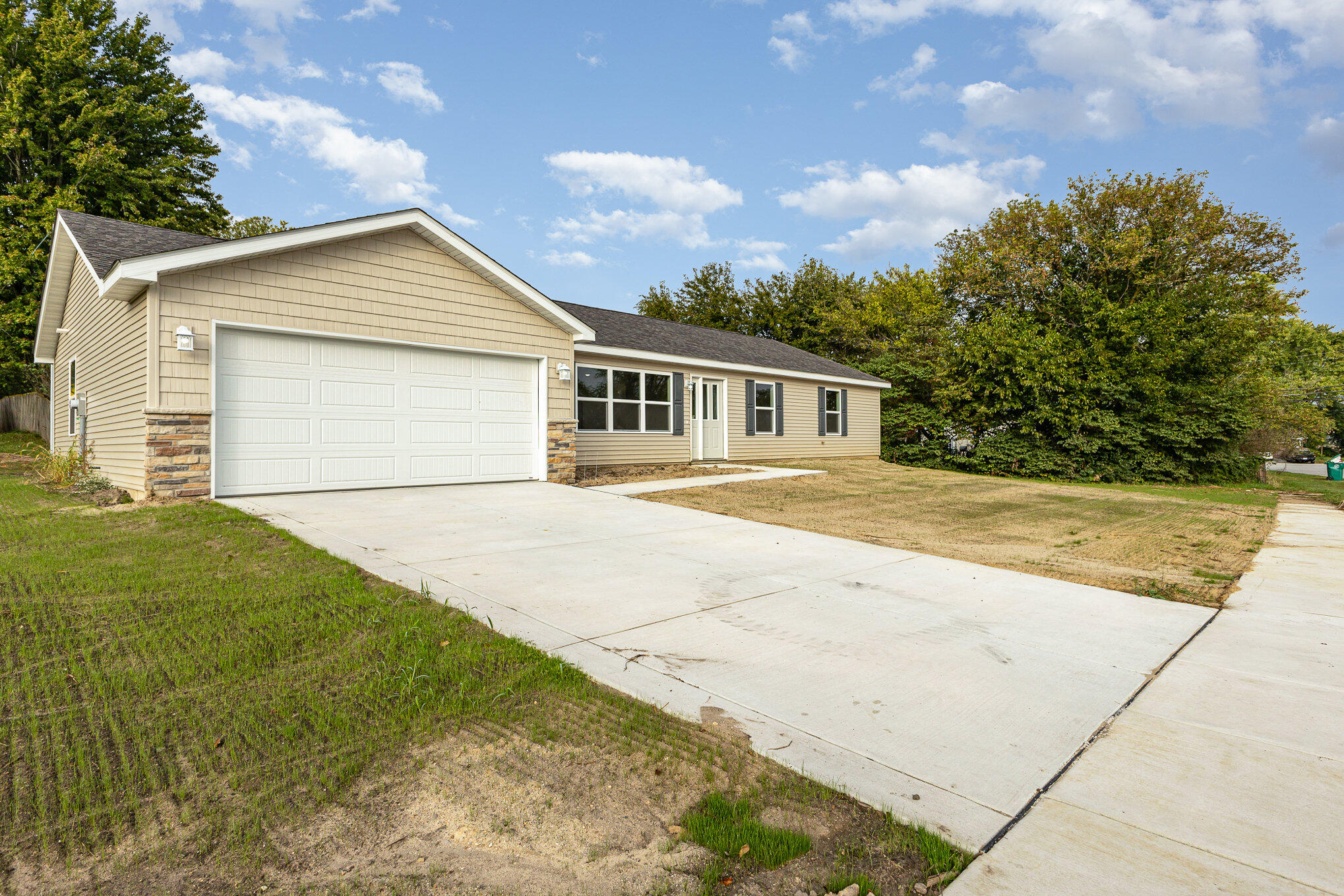 a view of backyard of house with green space