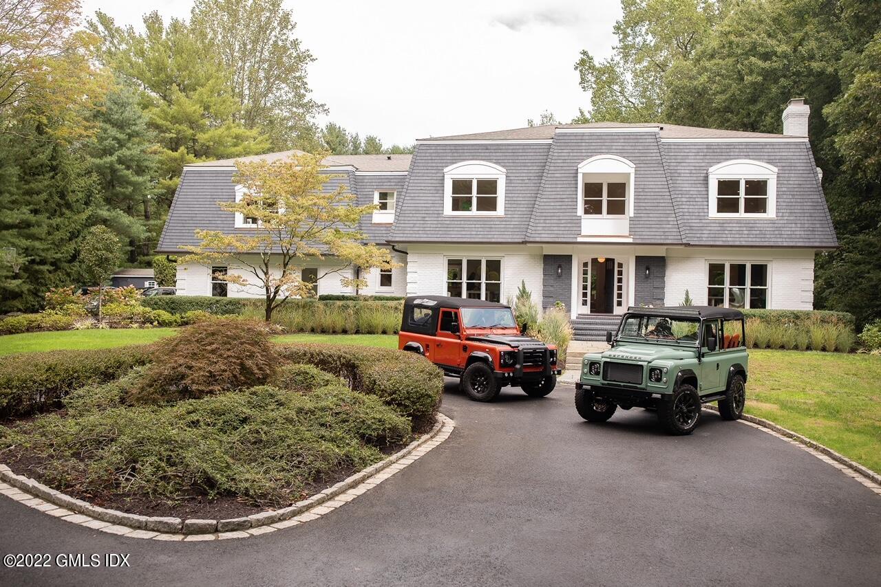 a couple of cars parked in front of a house