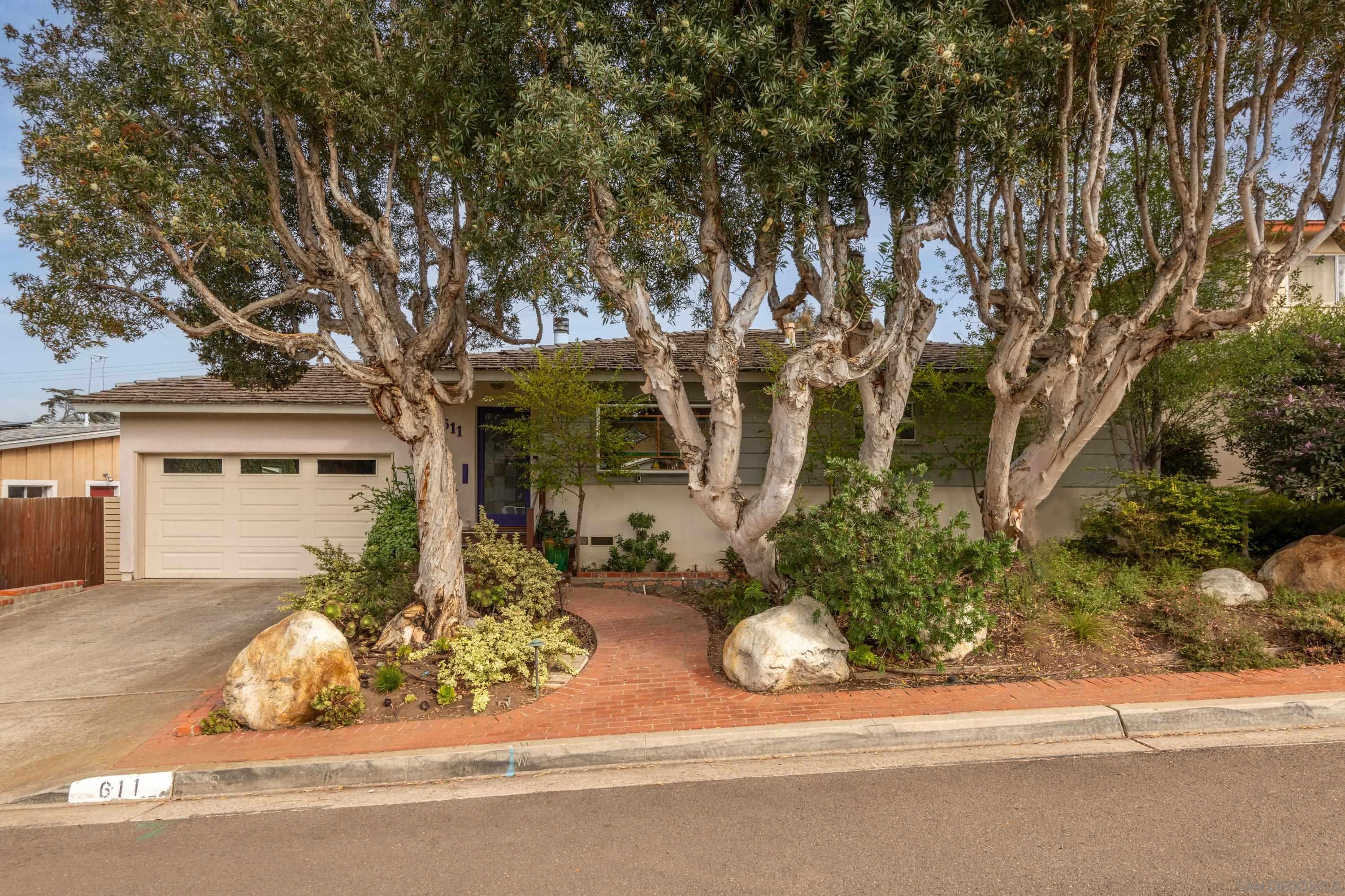 front view of a house with a tree