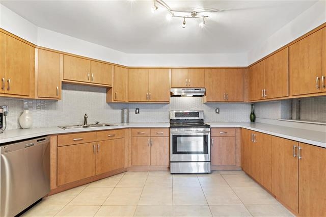 a kitchen with stainless steel appliances granite countertop a sink and cabinets