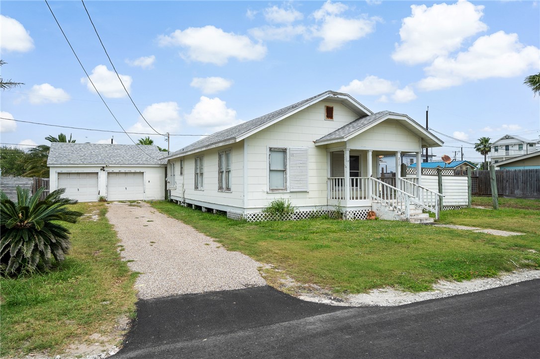 a front view of a house with a garden and yard