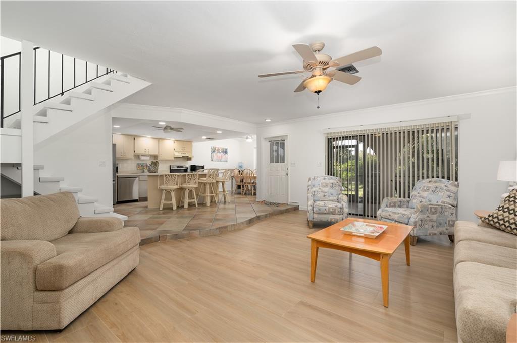 a living room with furniture and a table with wooden floor