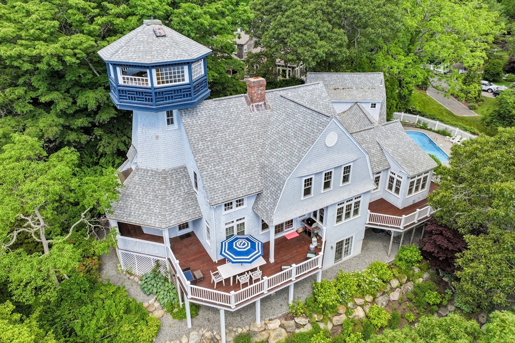 an aerial view of a house with garden space and street view