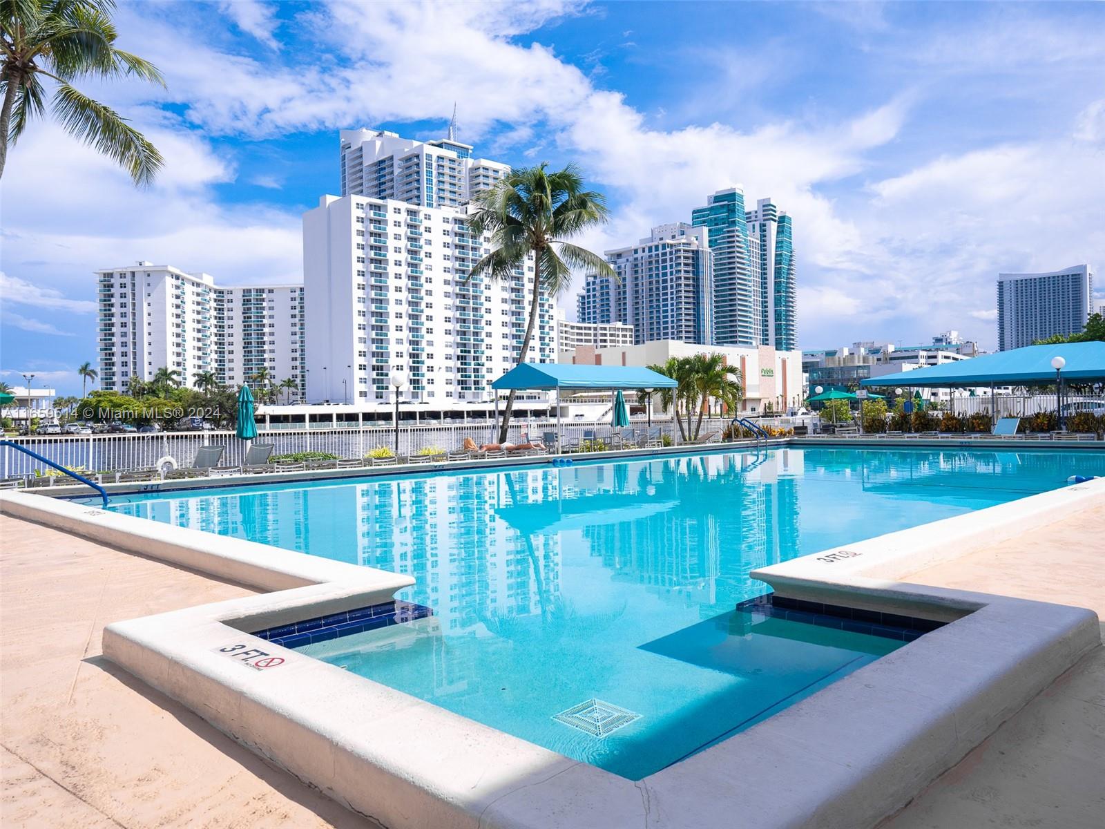 a view of swimming pool with outdoor seating and lake view