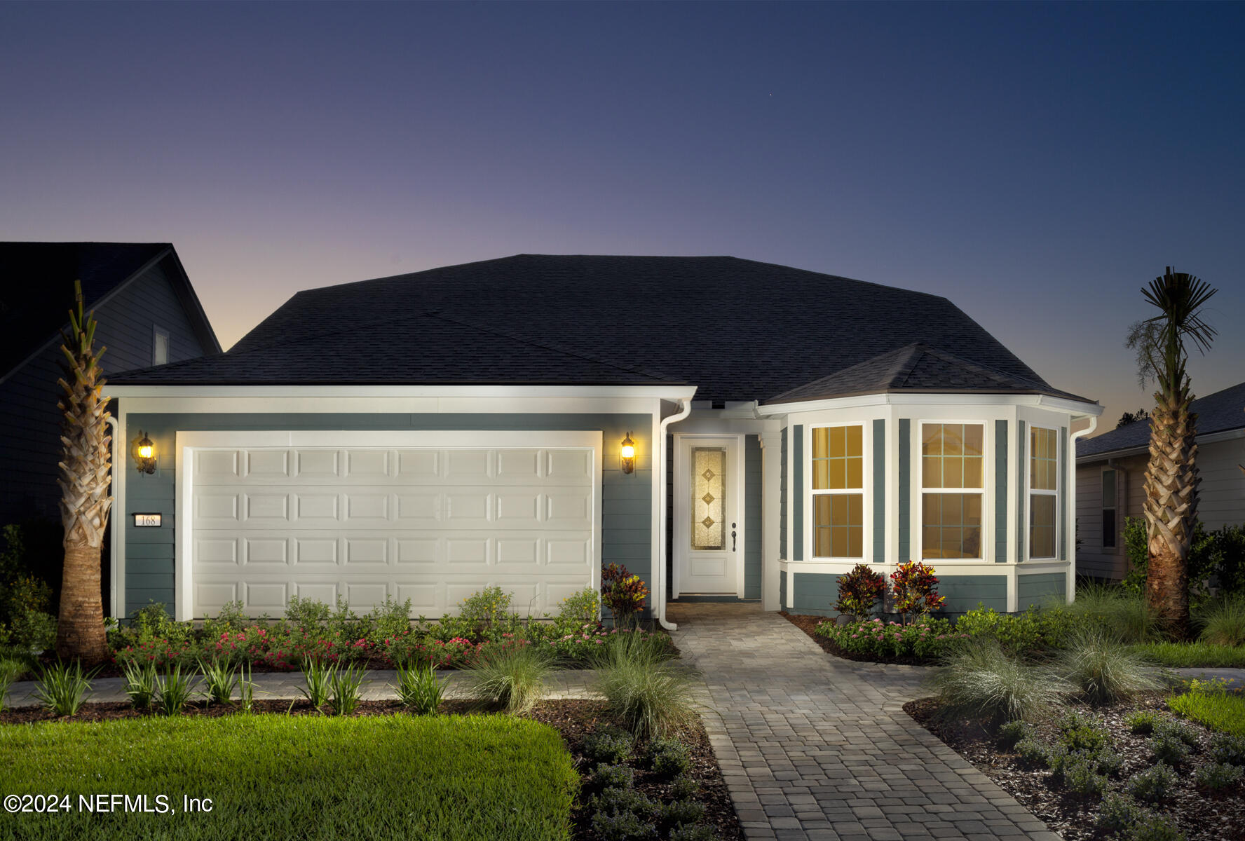 a front view of a house with garden