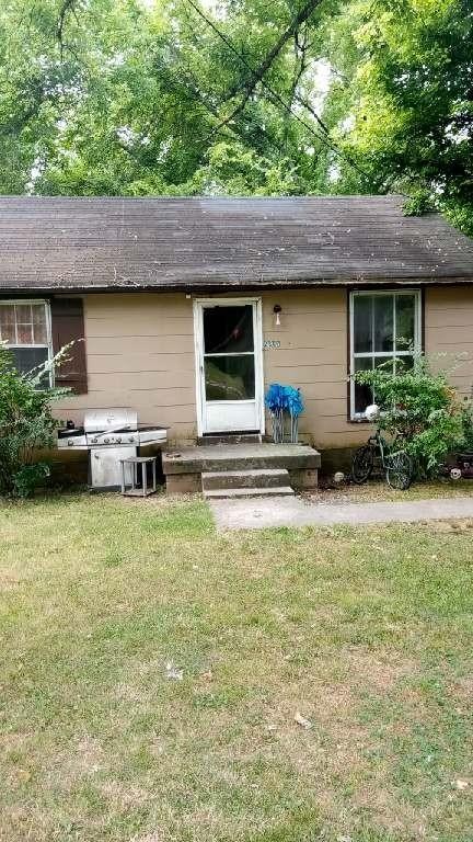 a backyard of a house with table and chairs