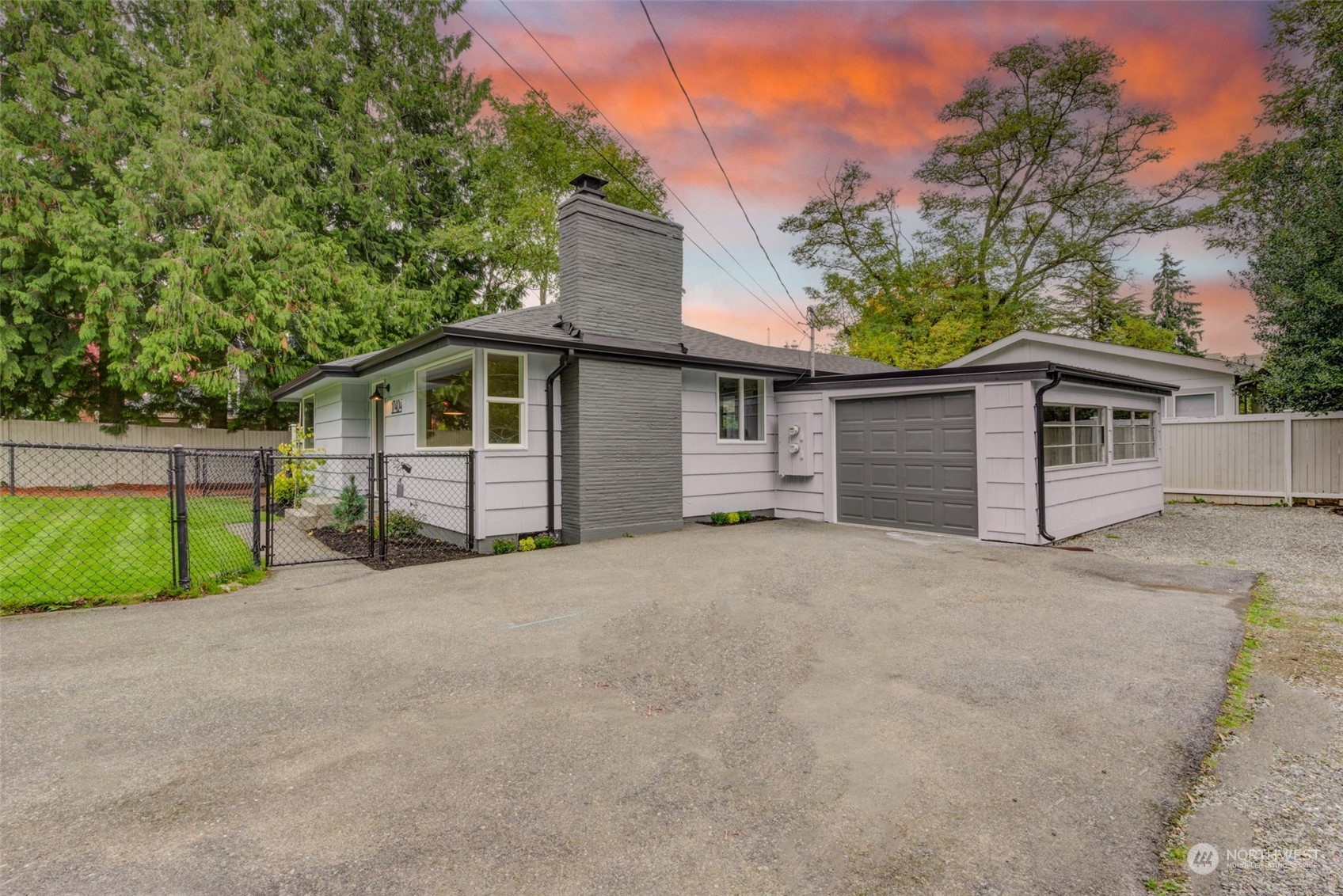 a view of a house with a yard and garage