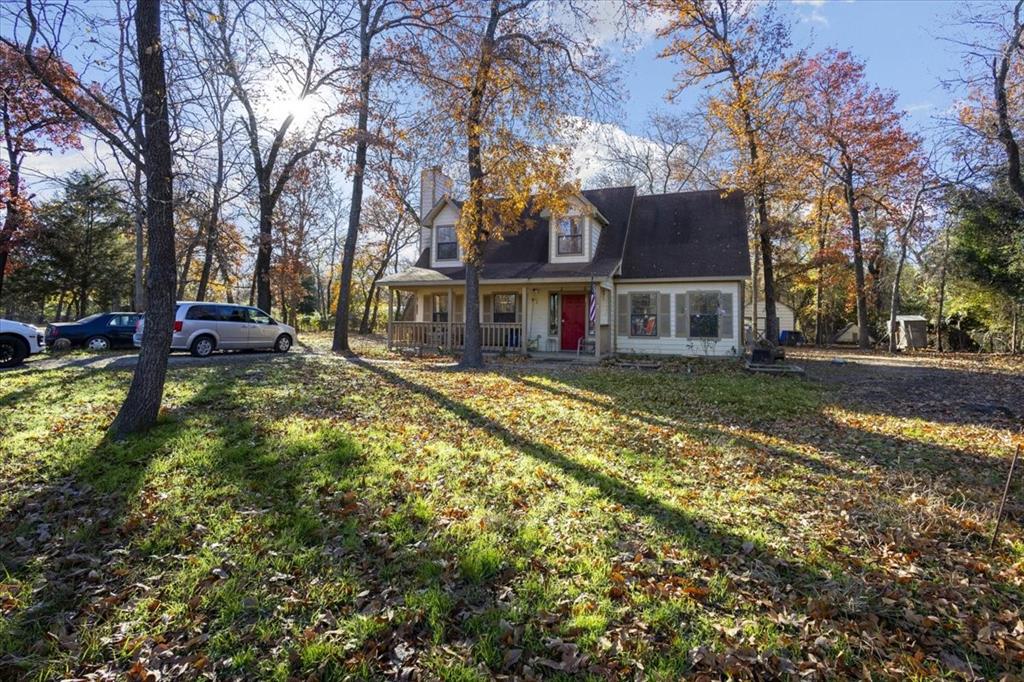 a view of a house with a yard patio and fire pit