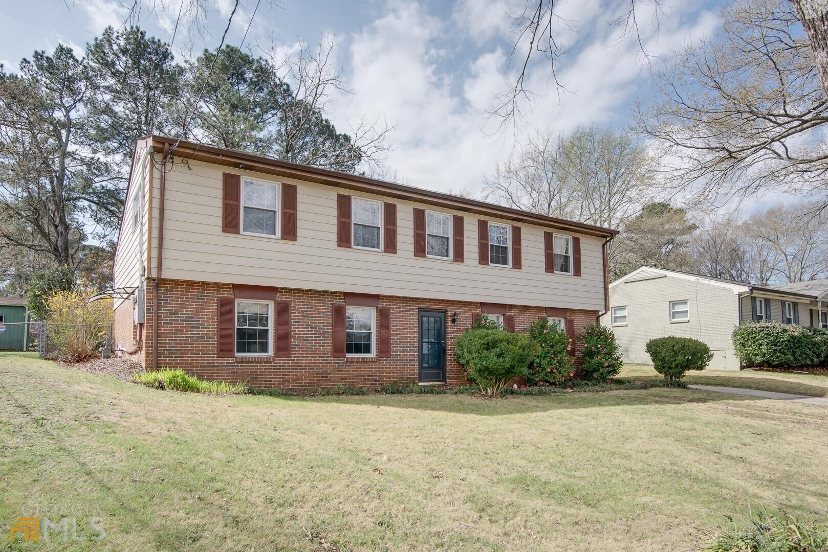 a front view of a house with garden