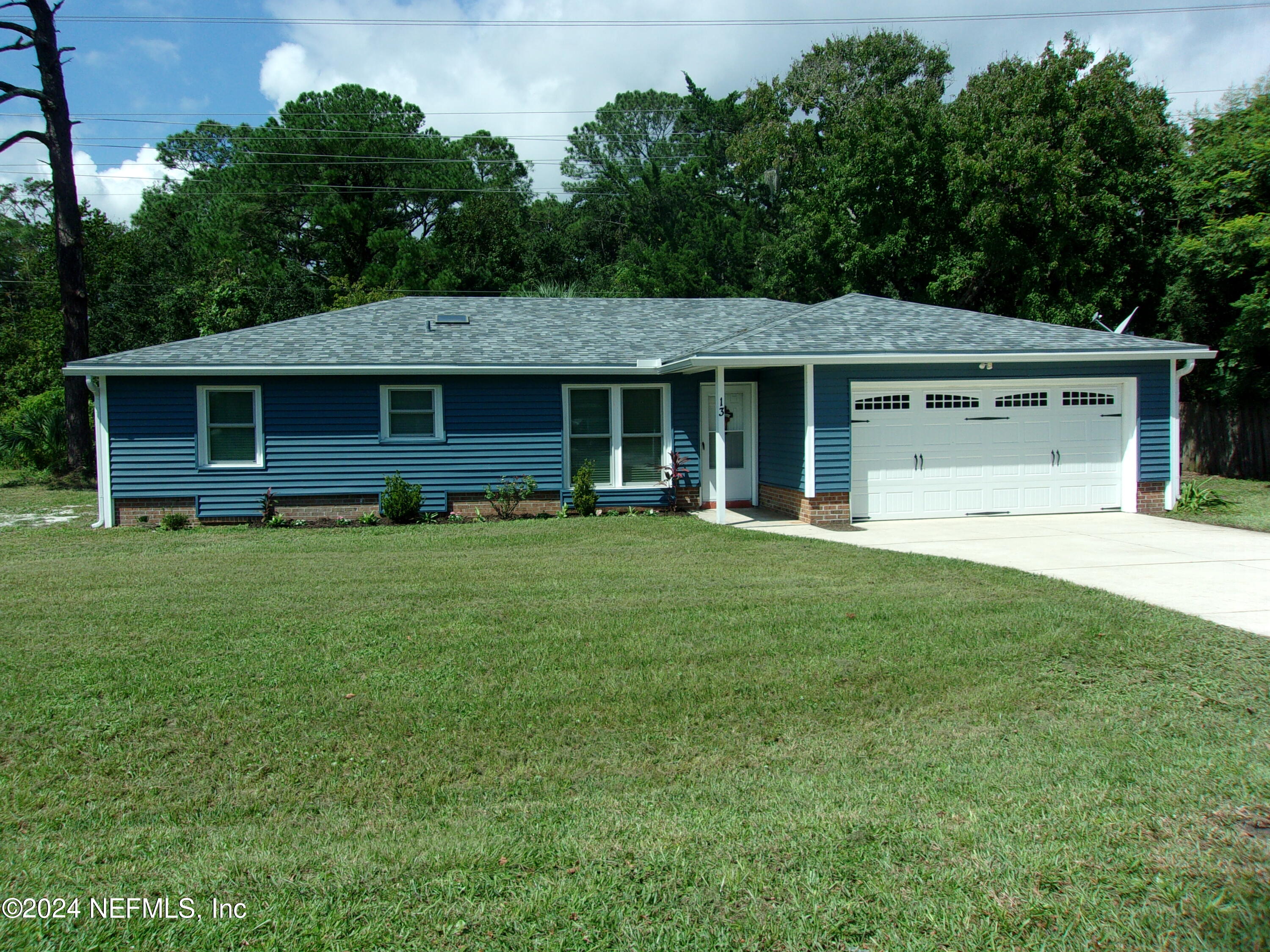 a front view of house with yard and green space