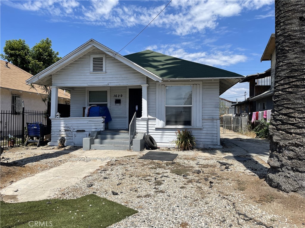 a front view of a house with a yard outdoor seating and garage