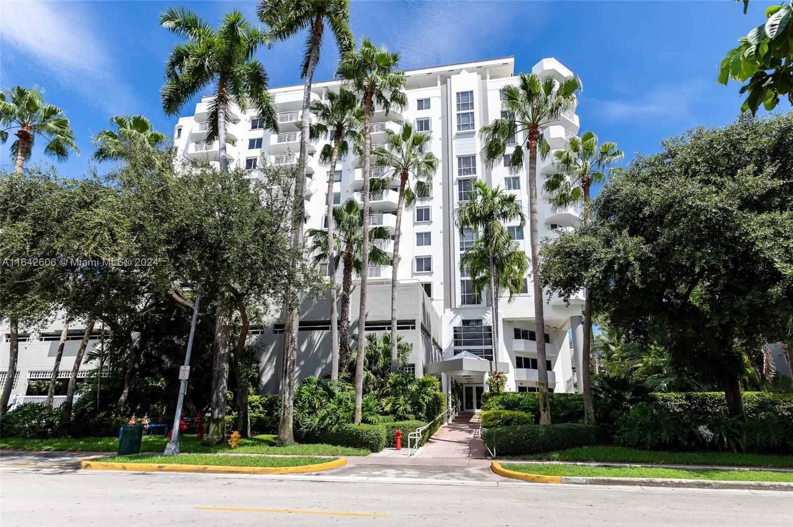 front view of a multi story building with a yard