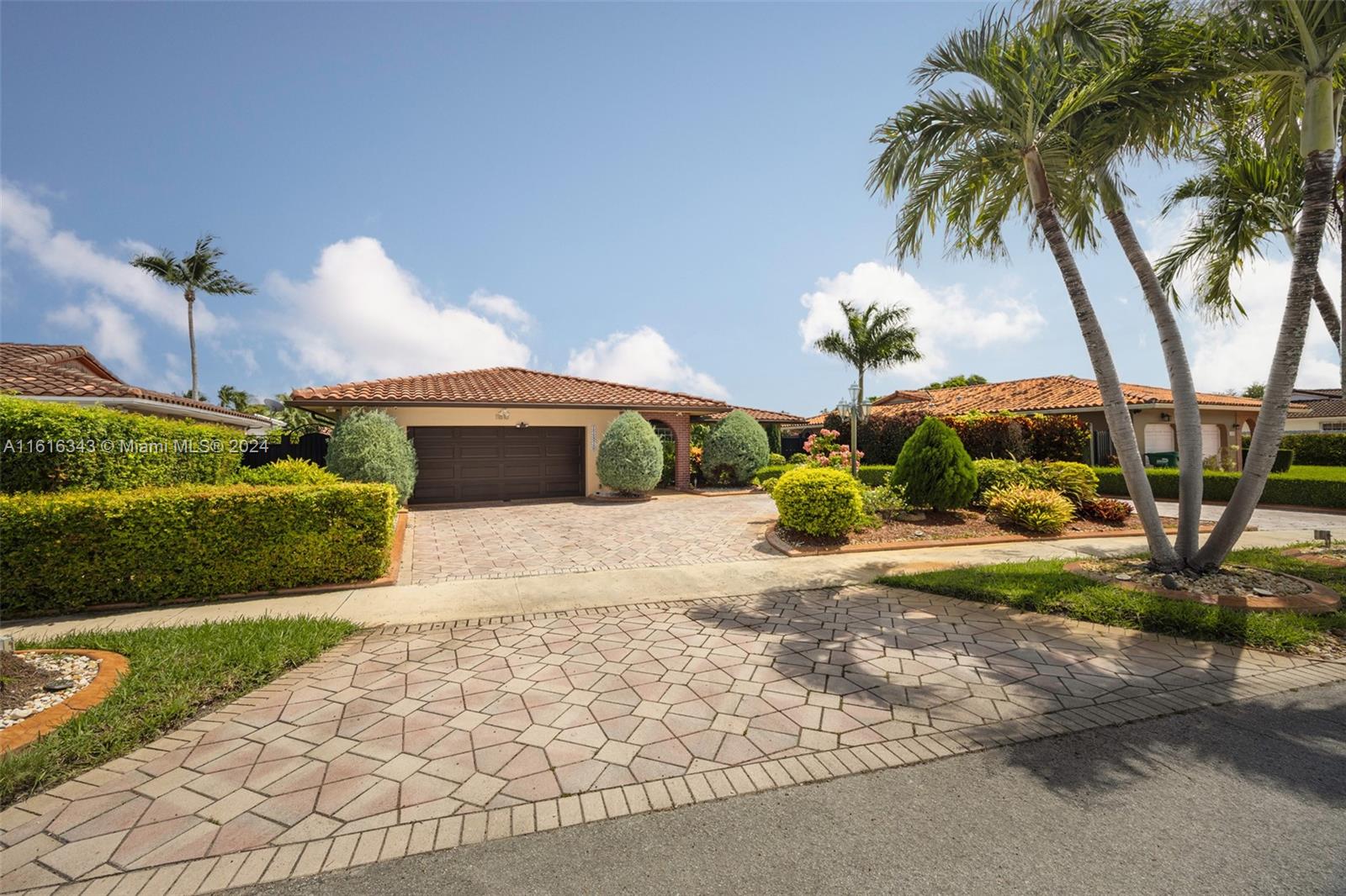 a front view of a house with garden and patio