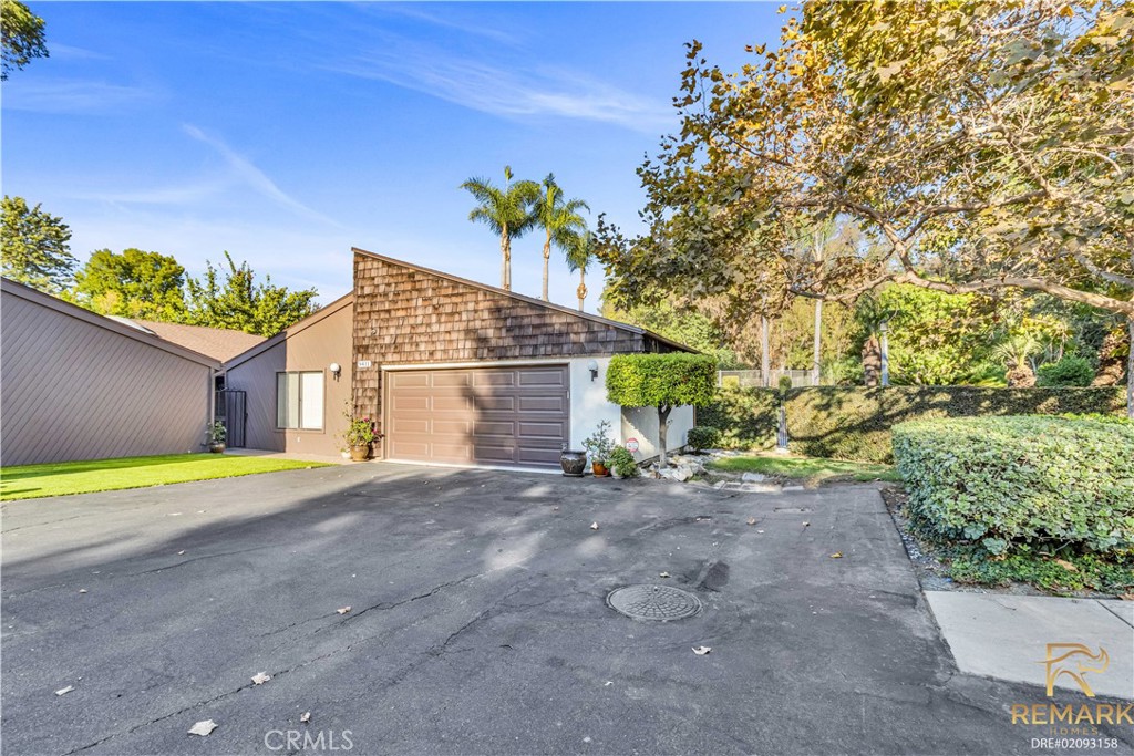 a view of a house with a yard and a garage