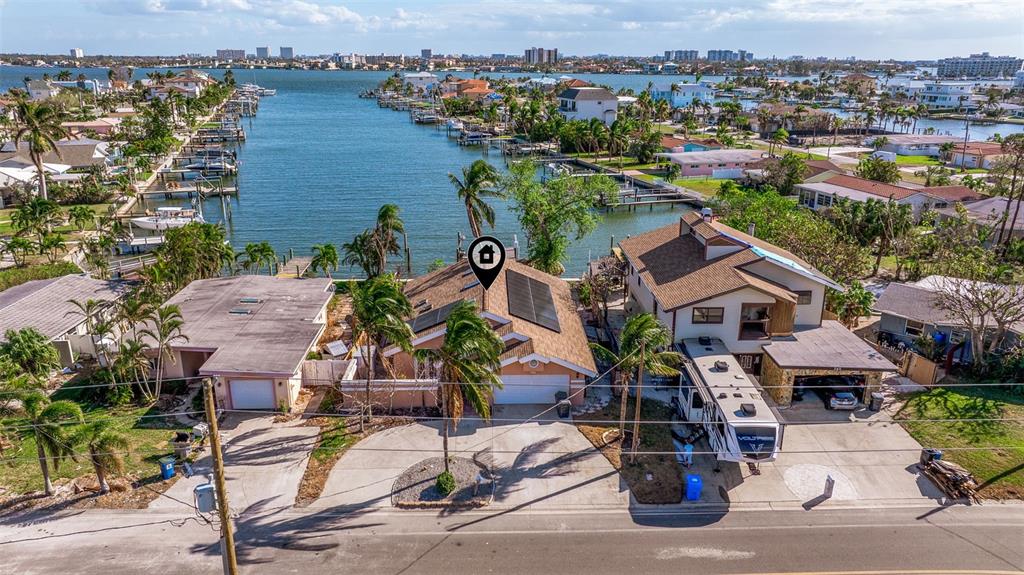 an aerial view of a house with outdoor space and lake view