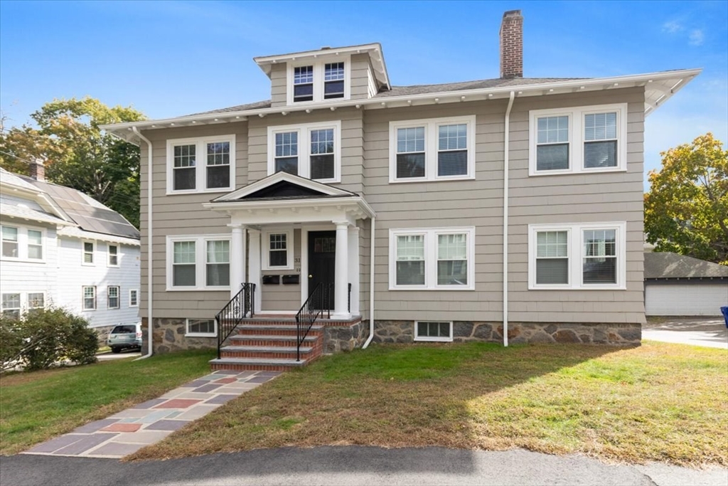 a front view of a house with garden