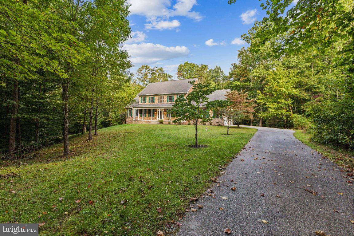 a view of a house with a backyard