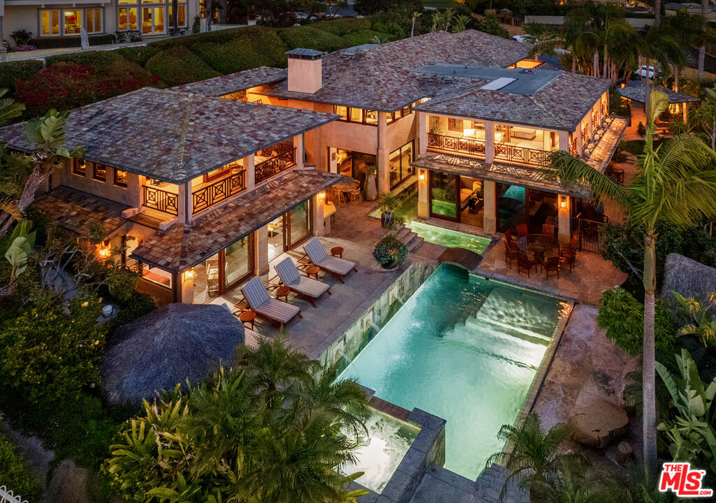 an aerial view of a house with a yard basket ball court and outdoor seating