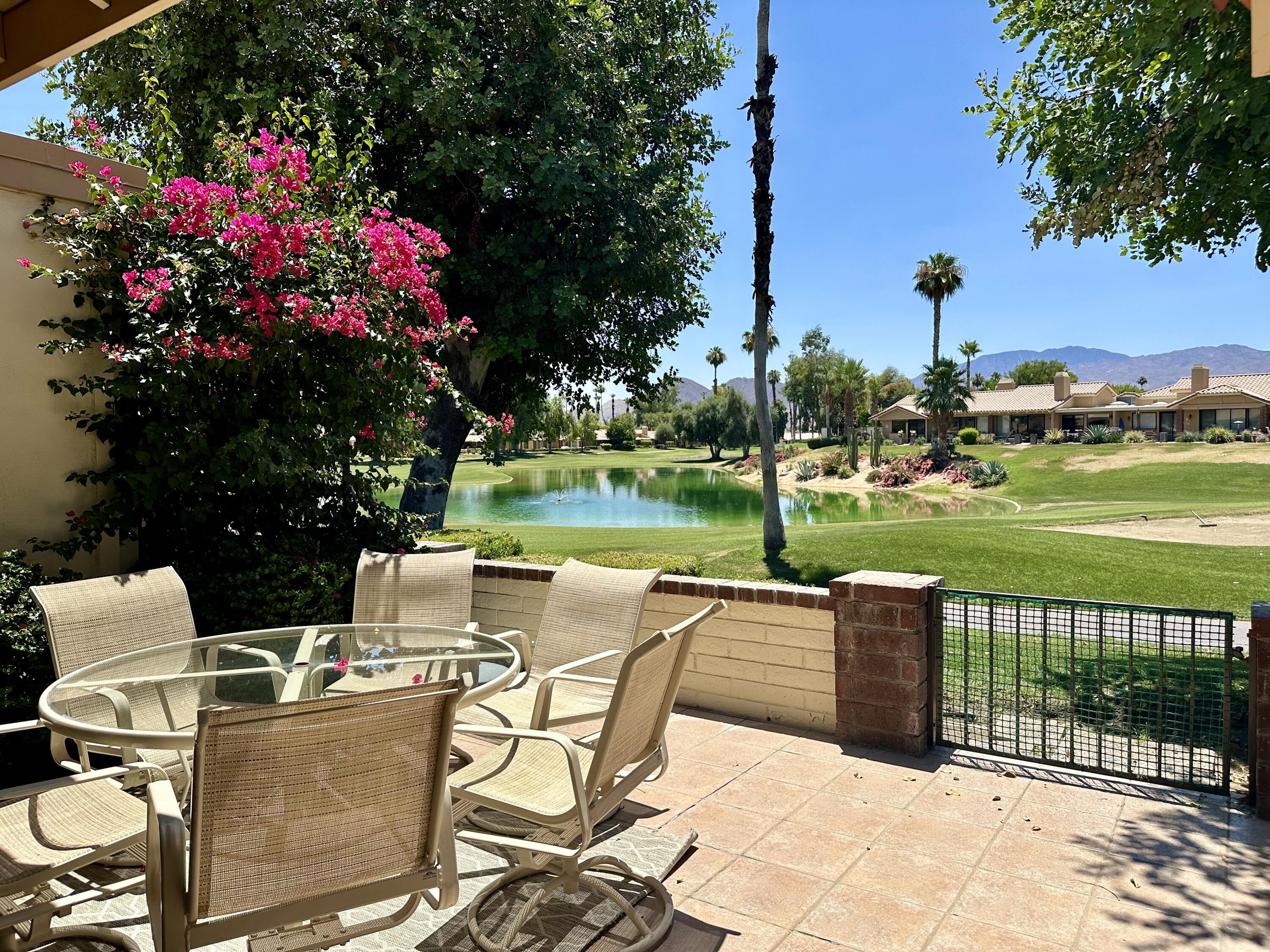 a view of a patio with a table & chairs