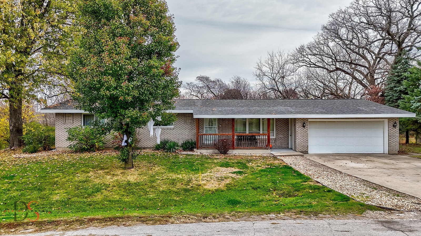 a front view of house with yard and green space