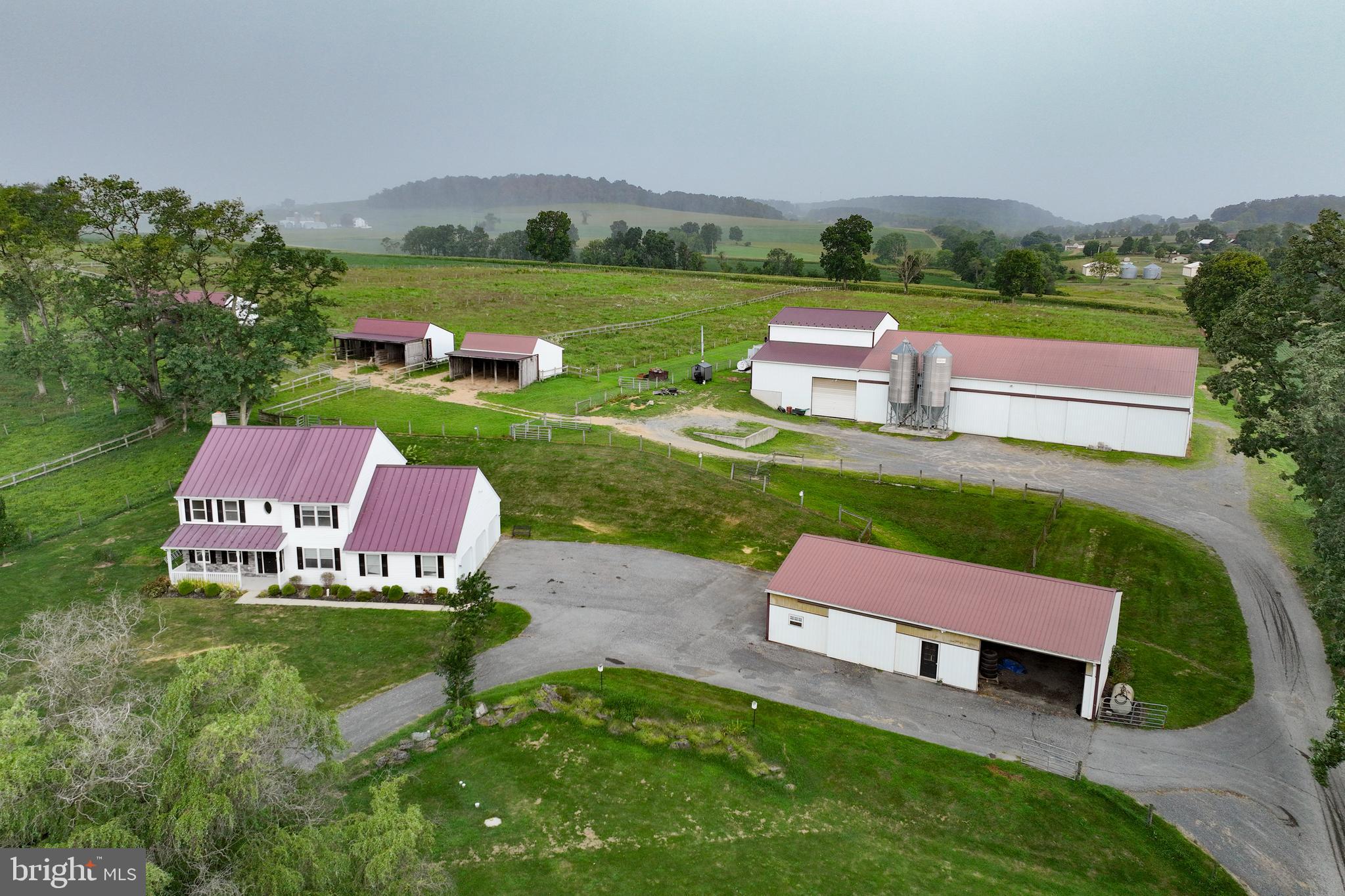 an aerial view of a garden with swimming pool and mountain view in back