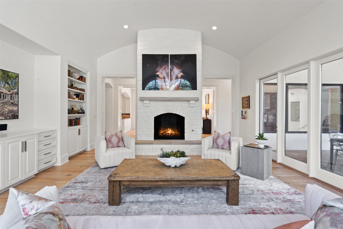 a living room with furniture fireplace and wooden floor